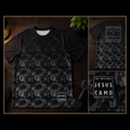 Black t-shirt with Jesus Camo pattern on a wooden surface