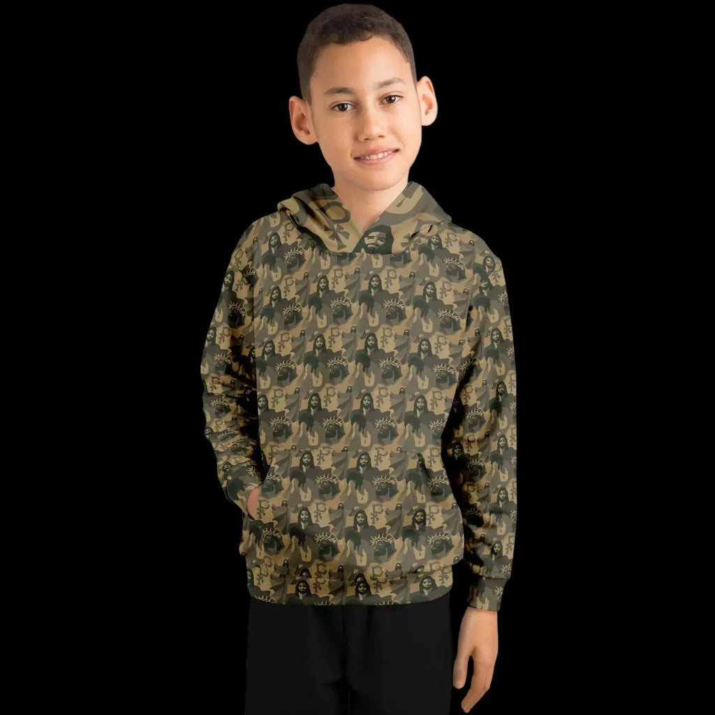 Mockup view of the front of a kids hoodie with a jesus camouflage pattern worn by a boy against a black background